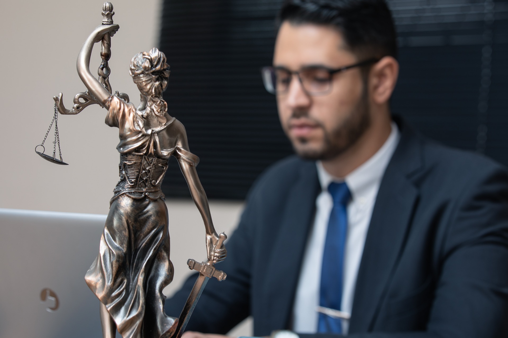 Attorney working beside Scales of Justice