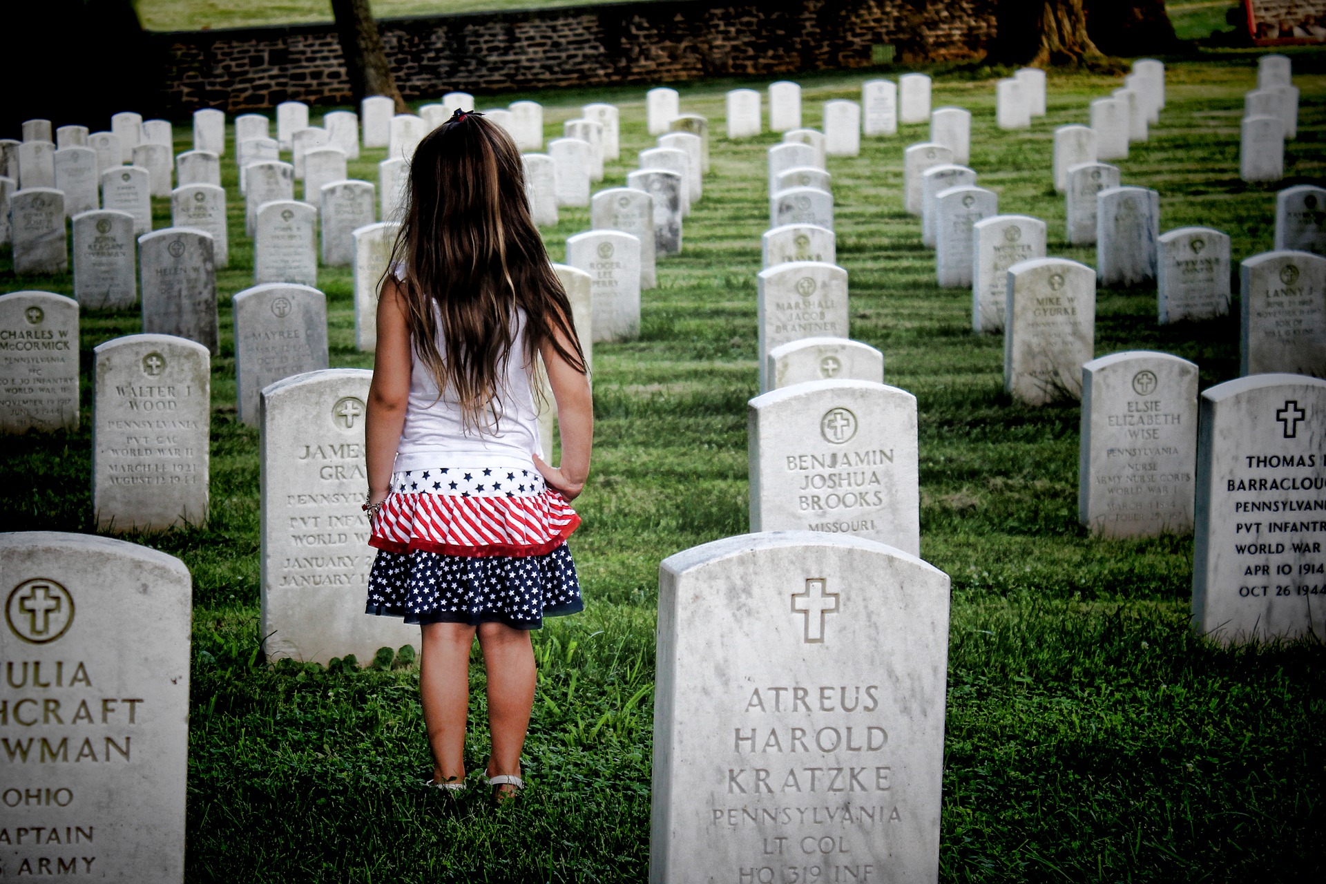 Young girl on graveyard with tombstones