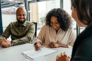 A woman signing paperwork