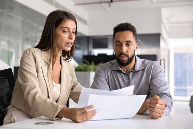 woman reviewing paperwork with a man