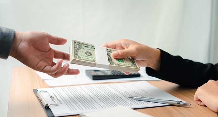 two hands with one receiving money